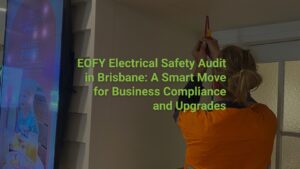 Licensed electrician performing an electrical safety audit in a Brisbane commercial building